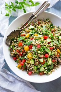 summer salad with fresh tomatoes, cucumbers, and farro